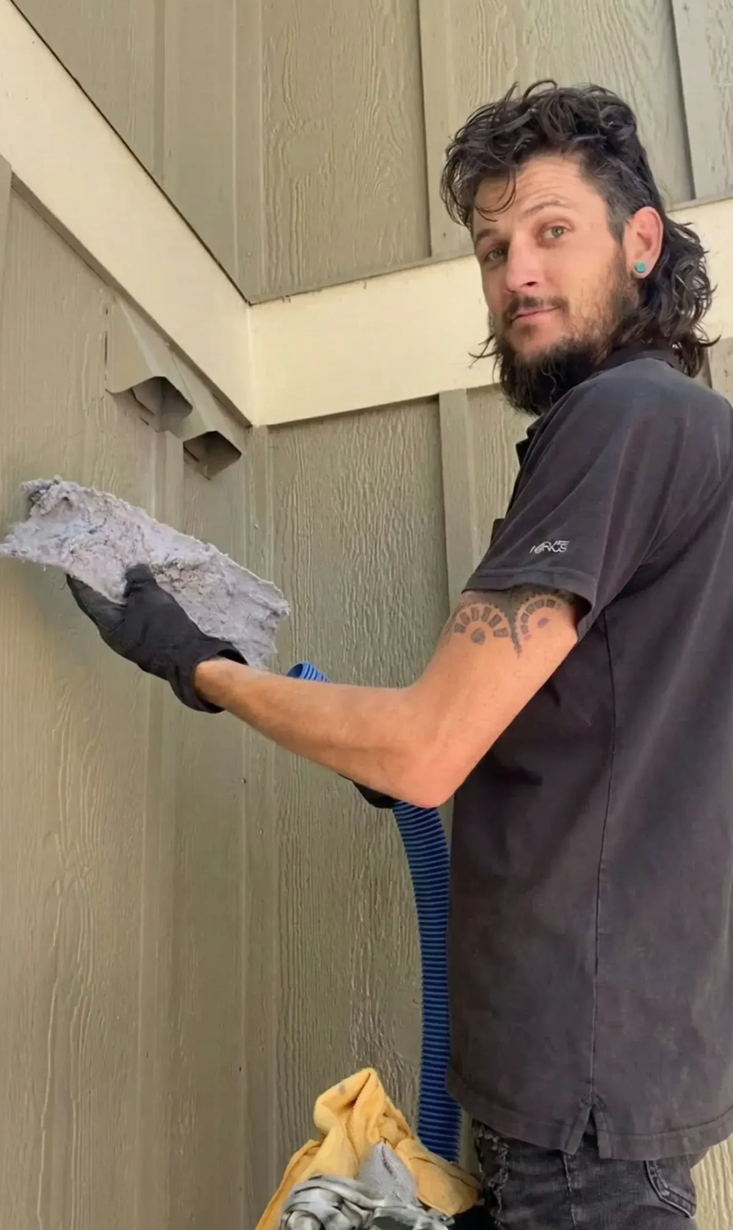 Jake holding up a dirty furnace filter next to an open return vent